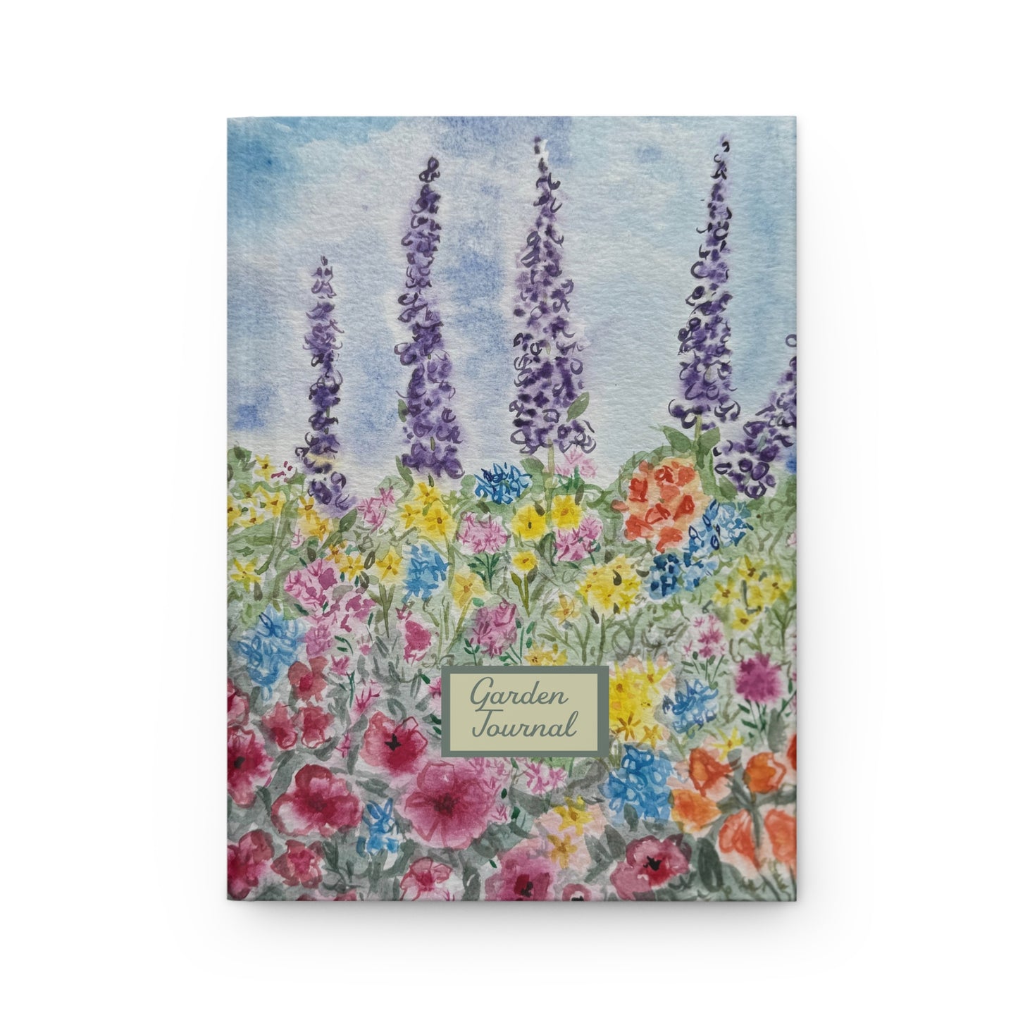 Watercolor garden journal with wildflower meadow and purple lupine flowers on soft blue background Floral notebook with 'Garden Journal' text on a white background