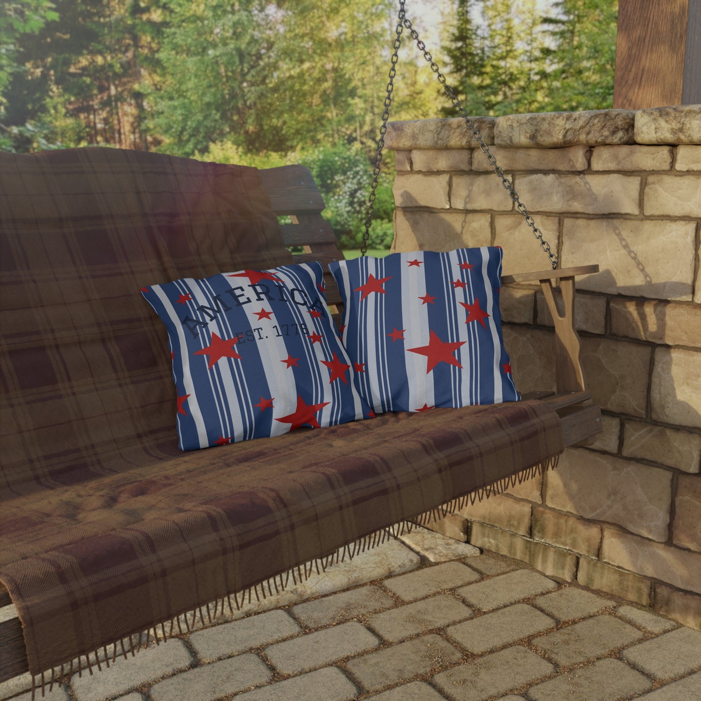 Brown swing with floral-patterned cushions in an outdoor setting with stone wall and greenery.