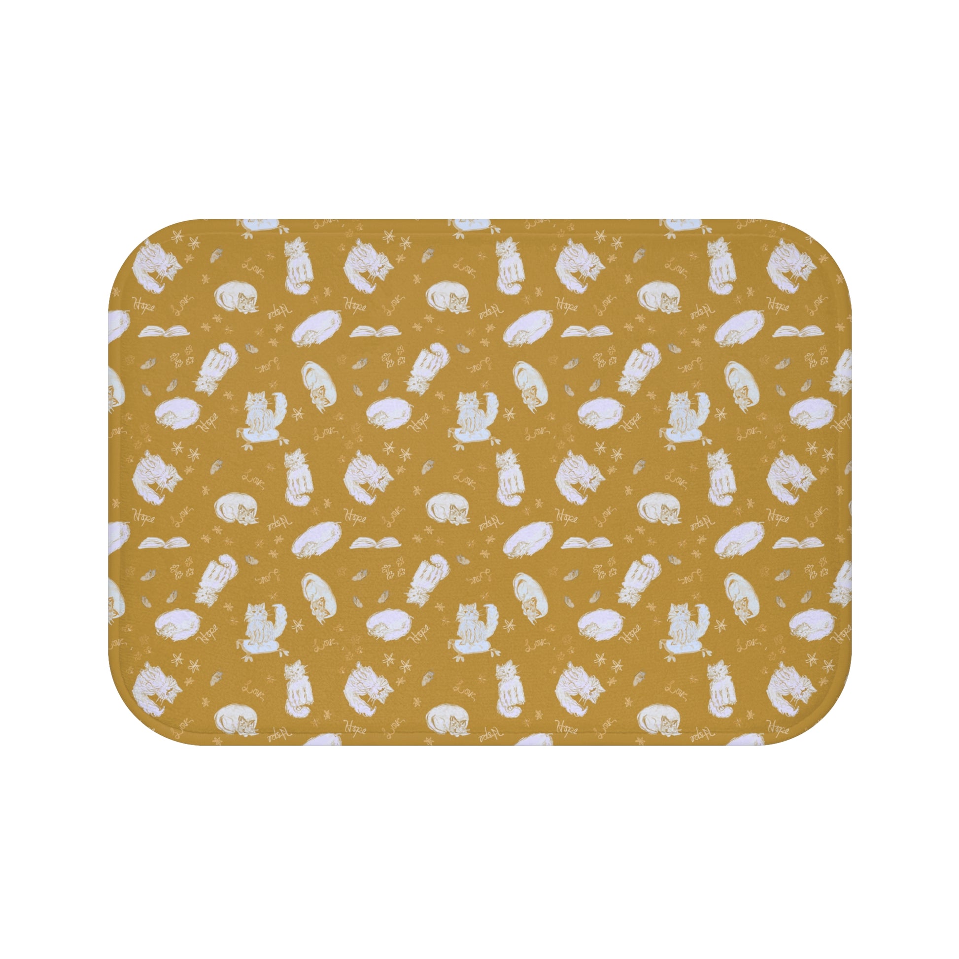Mustard yellow bath mat featuring a cozy repeating pattern of sleeping and fluffy cats, books, stars, leaves, and handwritten words on a warm golden background, perfect for cat lovers and cozy home décor.