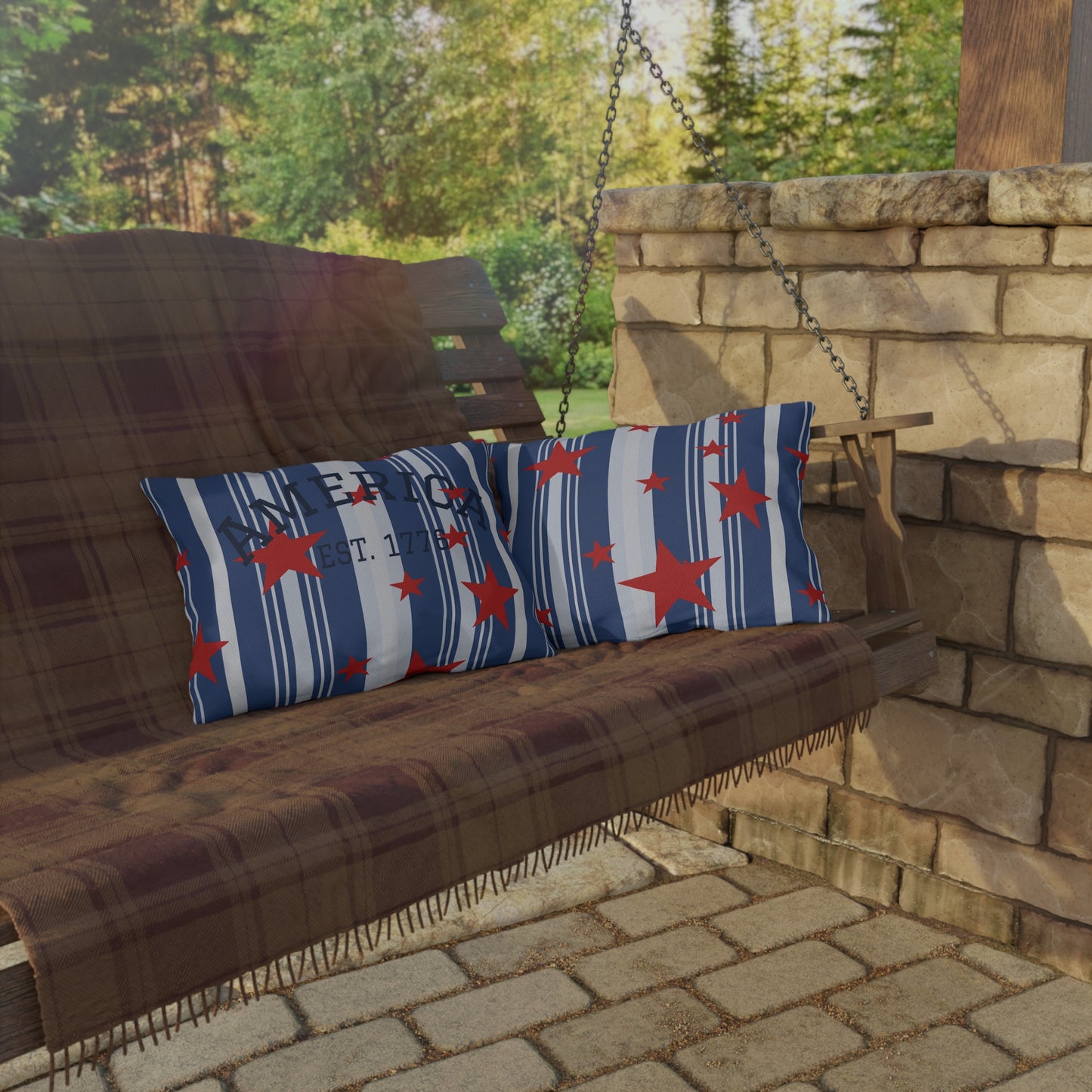 Wooden porch swing with decorative pillows on a stone patio