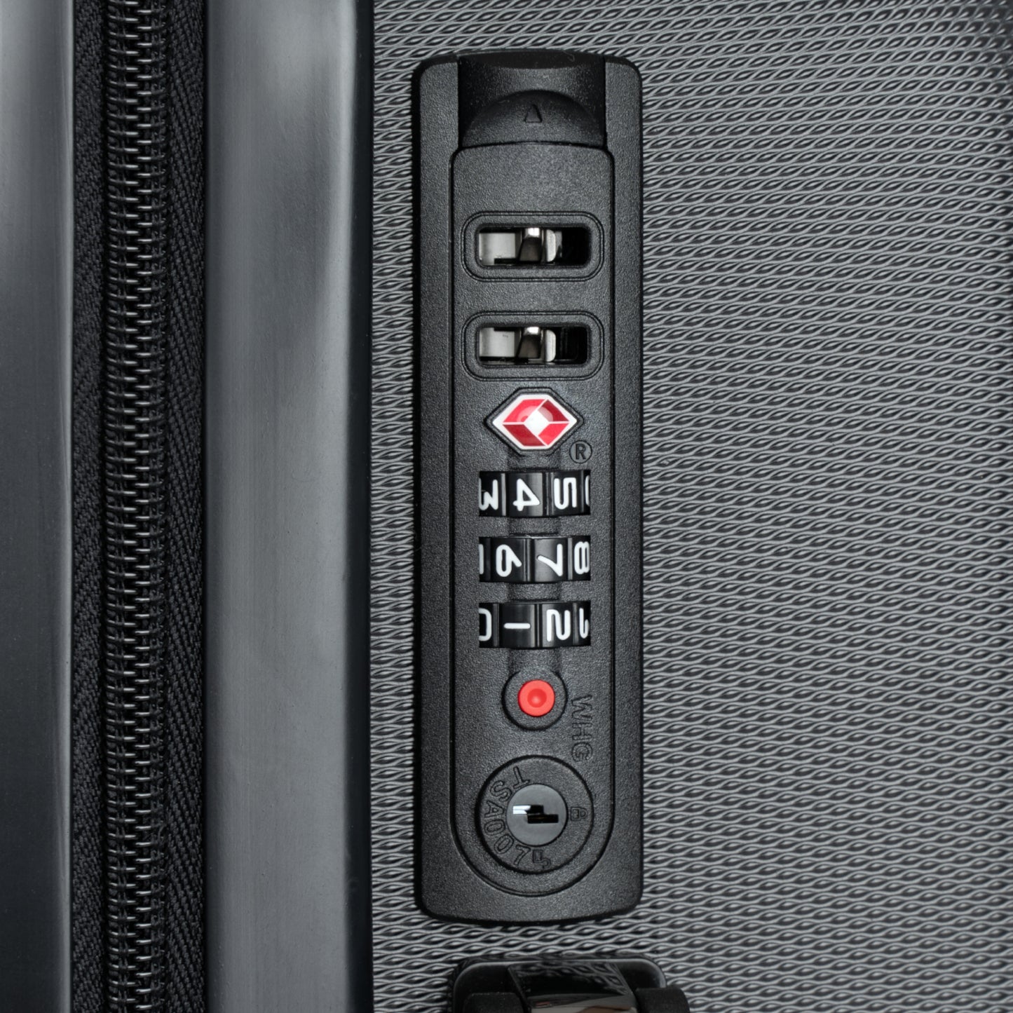 Close-up of a suitcase's combination lock on a textured gray surface