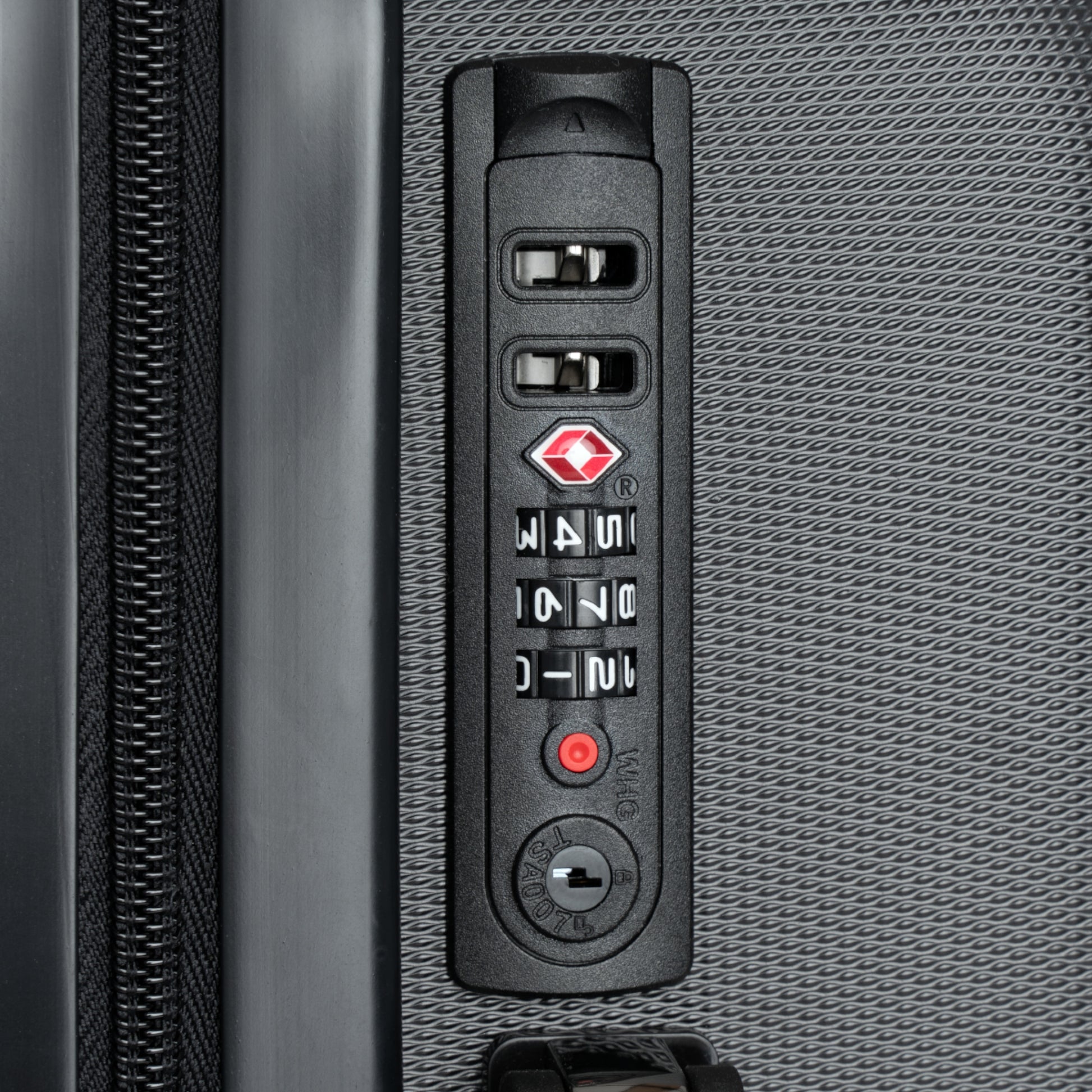 Close-up of a suitcase's combination lock on a textured gray surface
