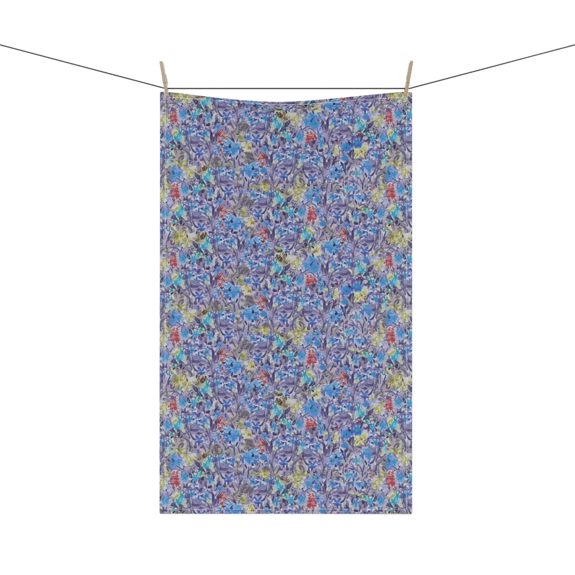 Watercolor floral tea towel with pink blossoms, earthy brown tones, and soft blue accents in a meadow-style pattern.