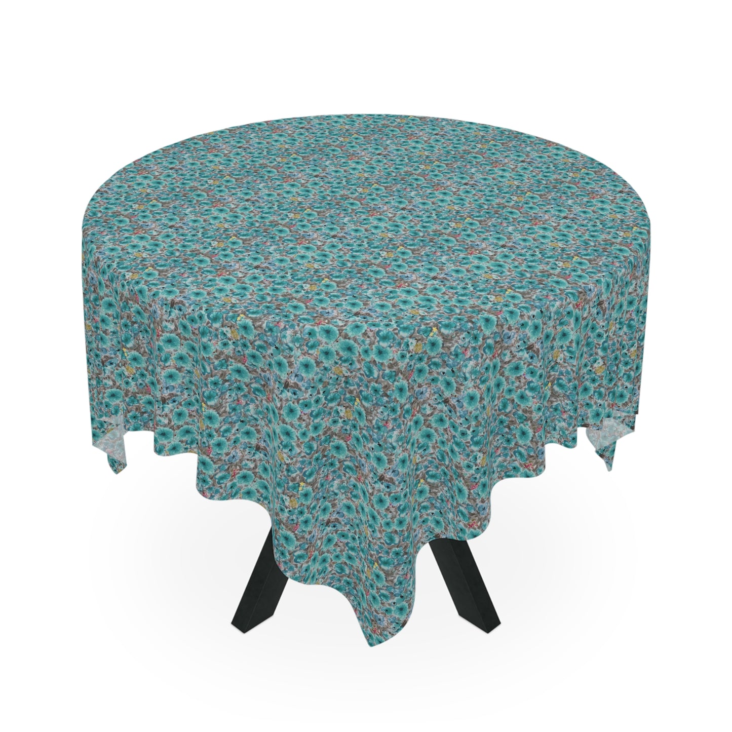 round table with teal floral tablecloth featuring dense watercolor wildflower pattern