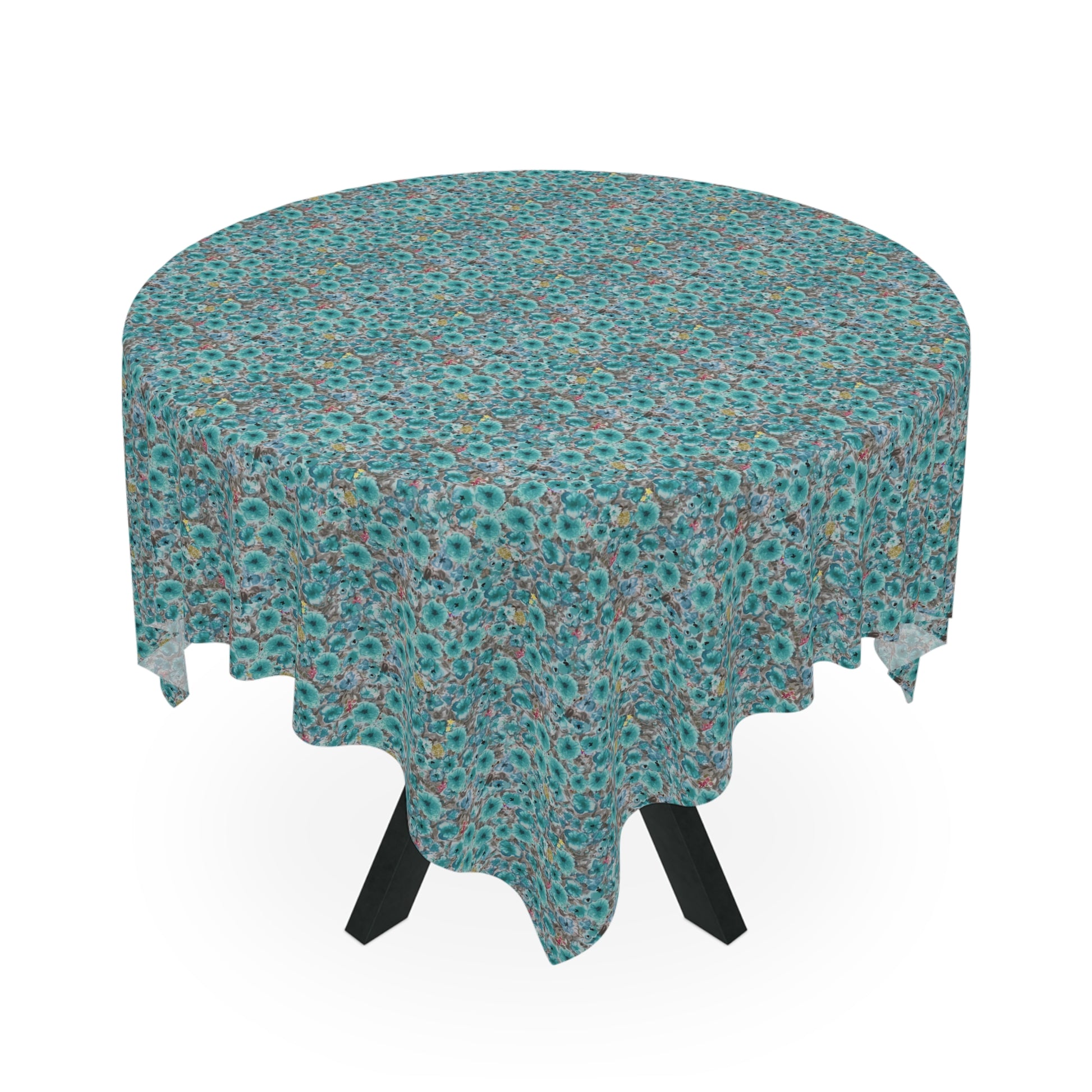 round table with teal floral tablecloth featuring dense watercolor wildflower pattern