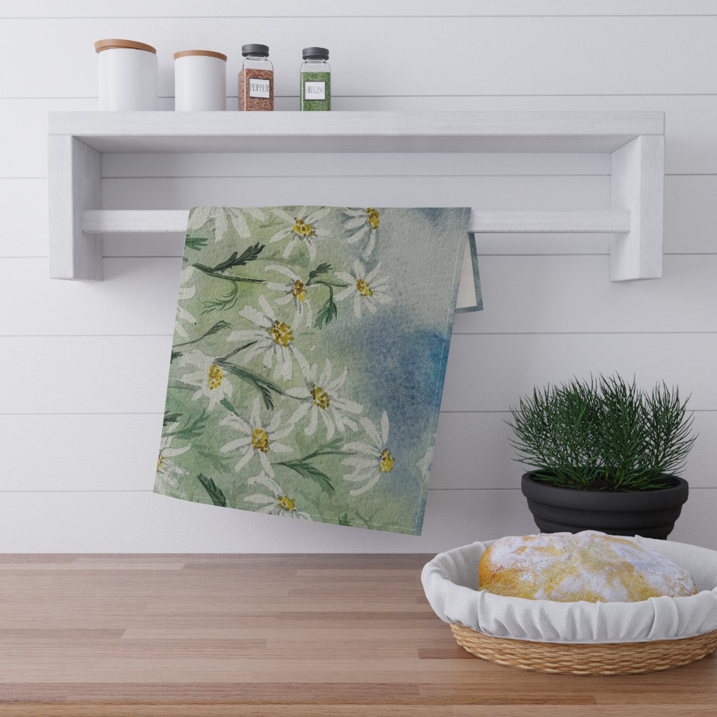 watercolor tea towel with loose daisy field pattern and soft green blue background