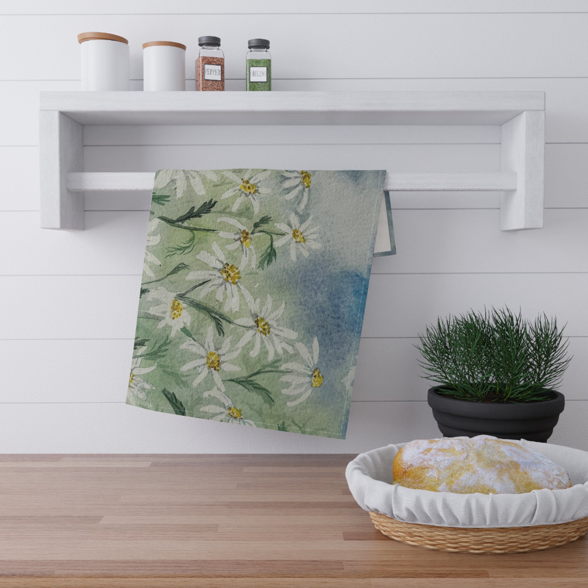 watercolor tea towel with loose daisy field pattern and soft green blue background