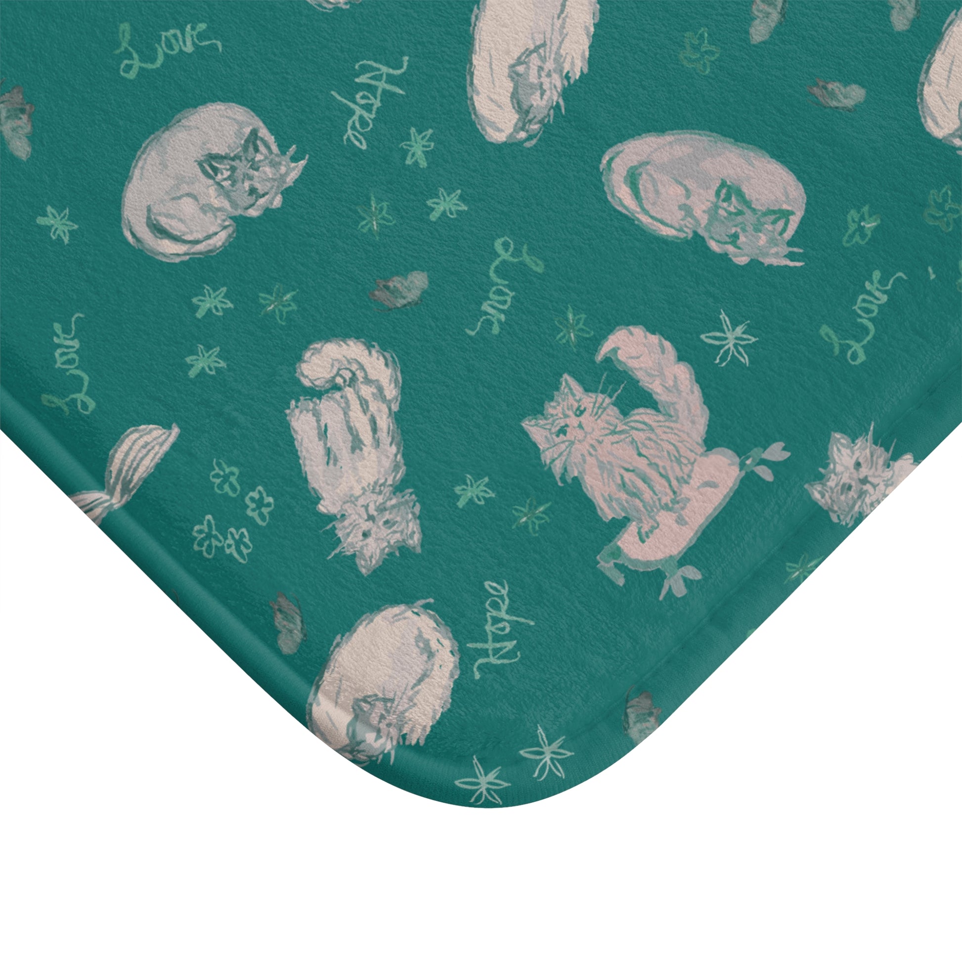 Teal fabric with white cat illustrations and text on a white background
