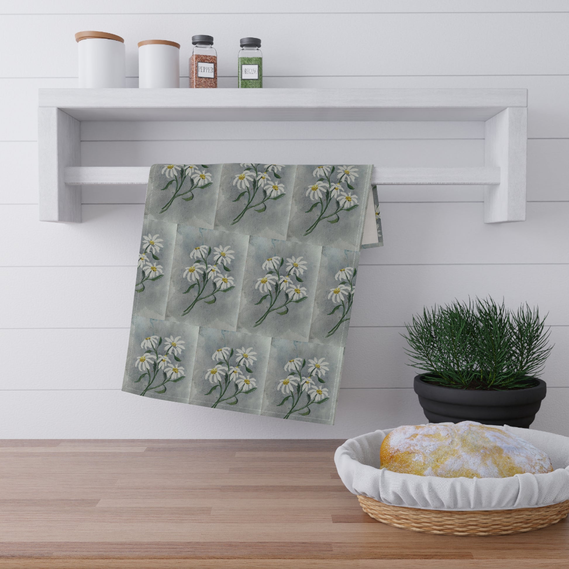 watercolor tea towel with repeating white daisy floral pattern on soft gray background