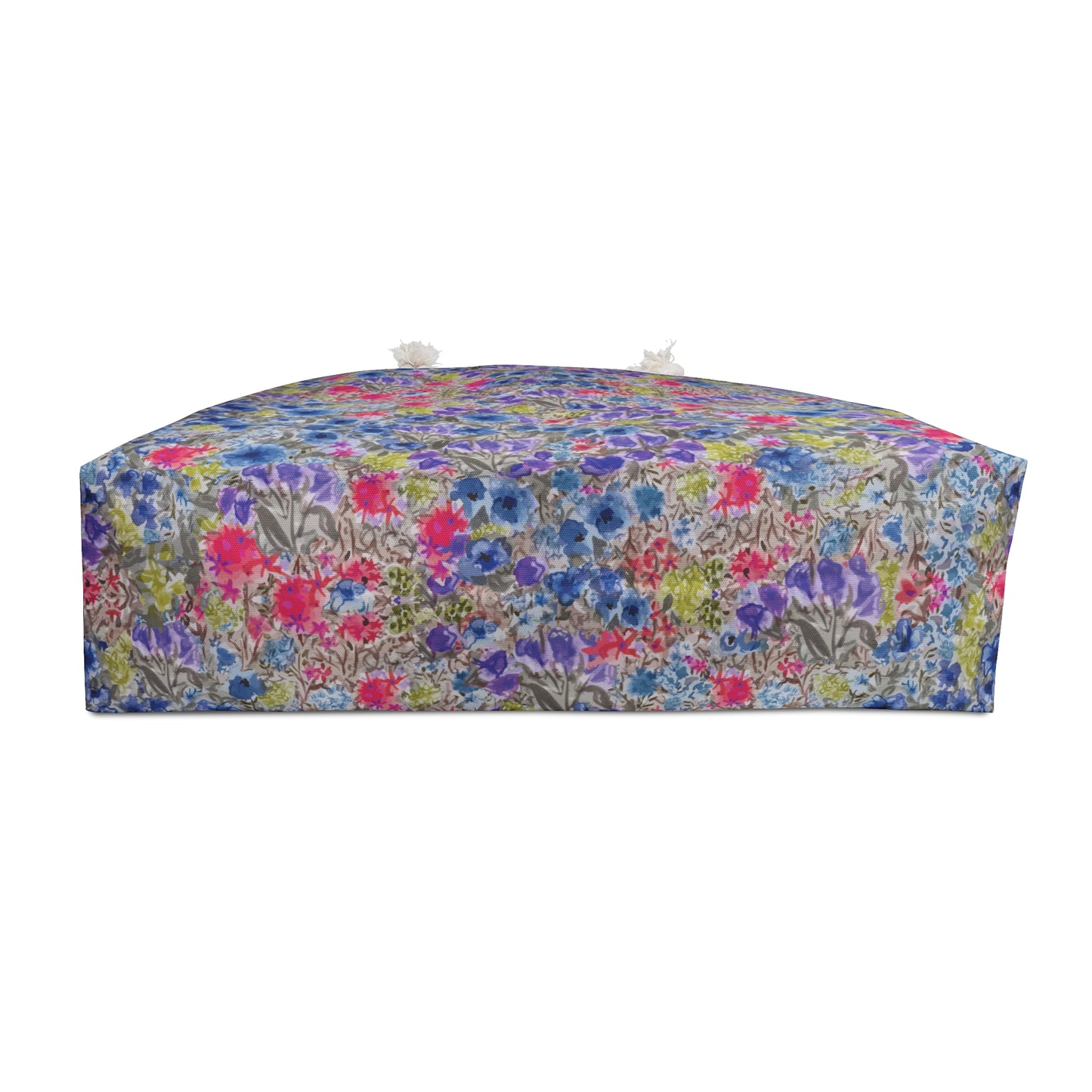 Bottom of Blue and pink watercolor wildflower weekender bag with a vibrant meadow floral pattern and white rope handles, designed as a spacious travel tote for beach trips and weekend getaways.