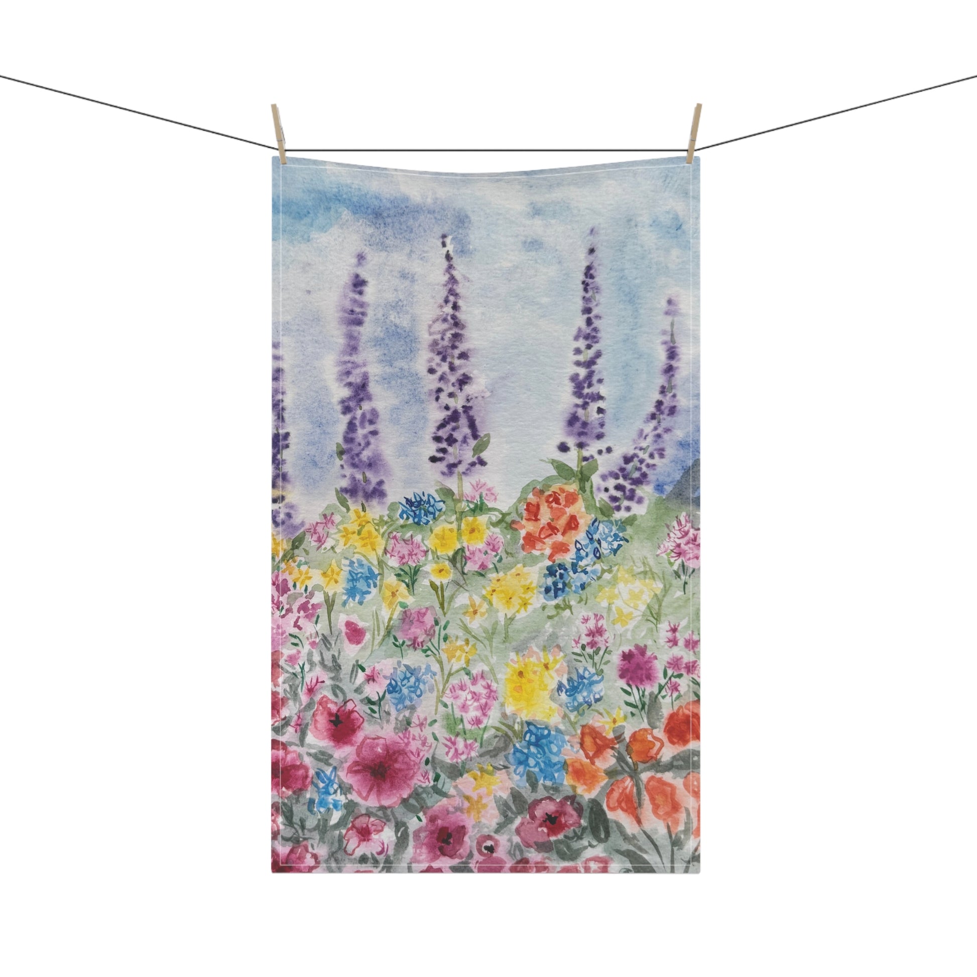 Watercolor floral tea towel featuring lavender stems and colorful wildflowers in soft blue, purple, pink, and yellow tones on a light background.