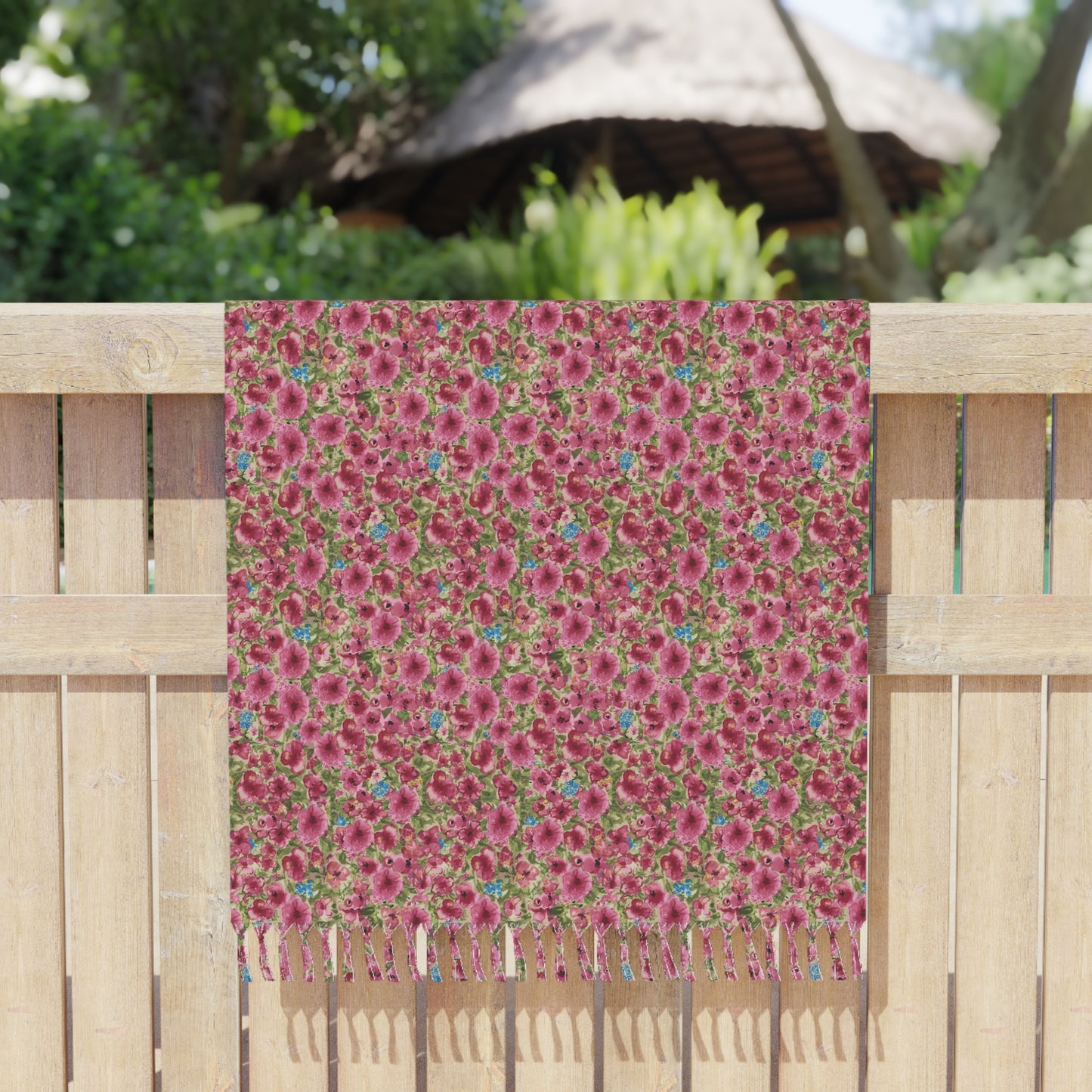 Pink watercolor poppies floral beach towel featuring a vibrant cottage garden botanical pattern draped over a fence.