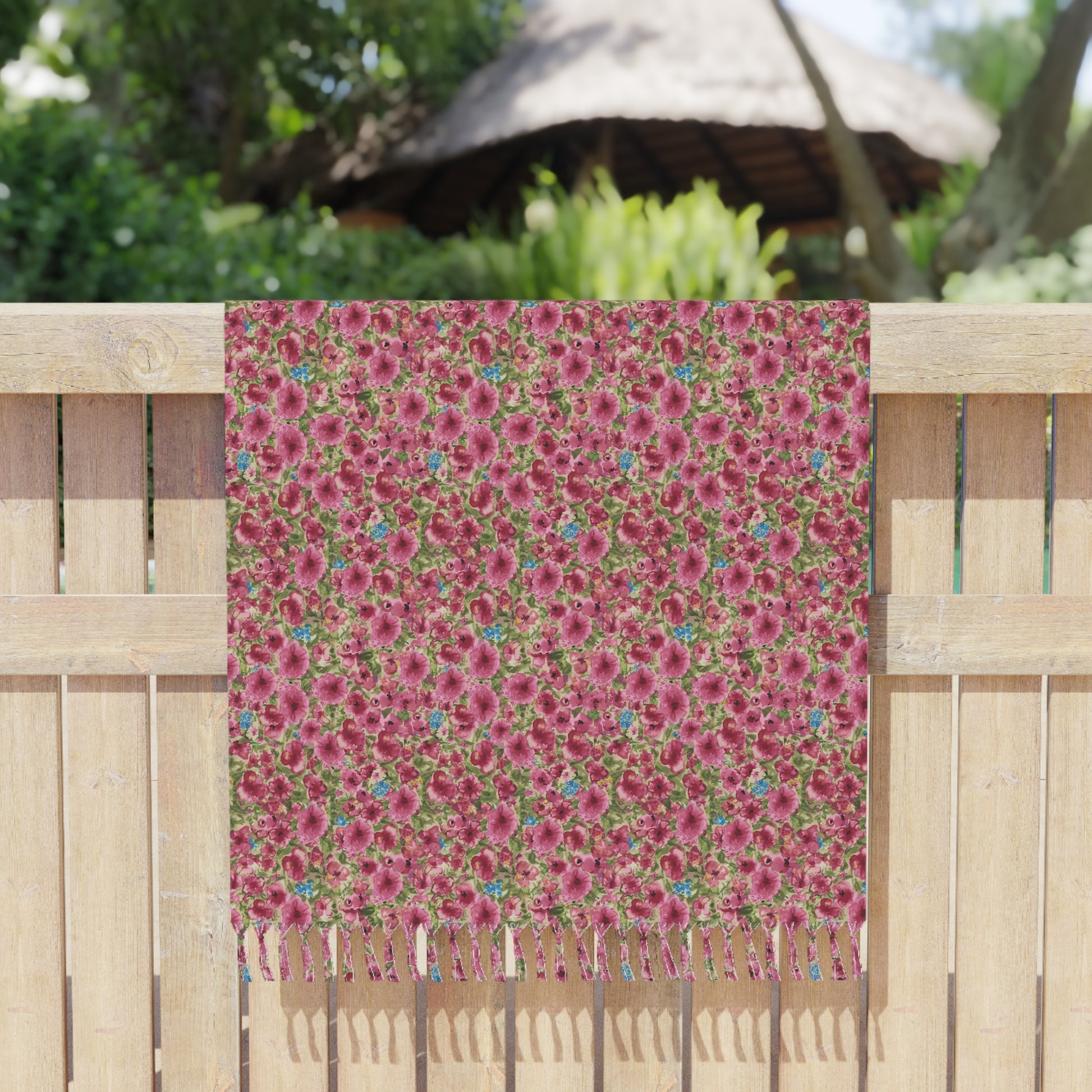 Pink watercolor poppies floral beach towel featuring a vibrant cottage garden botanical pattern draped over a fence.