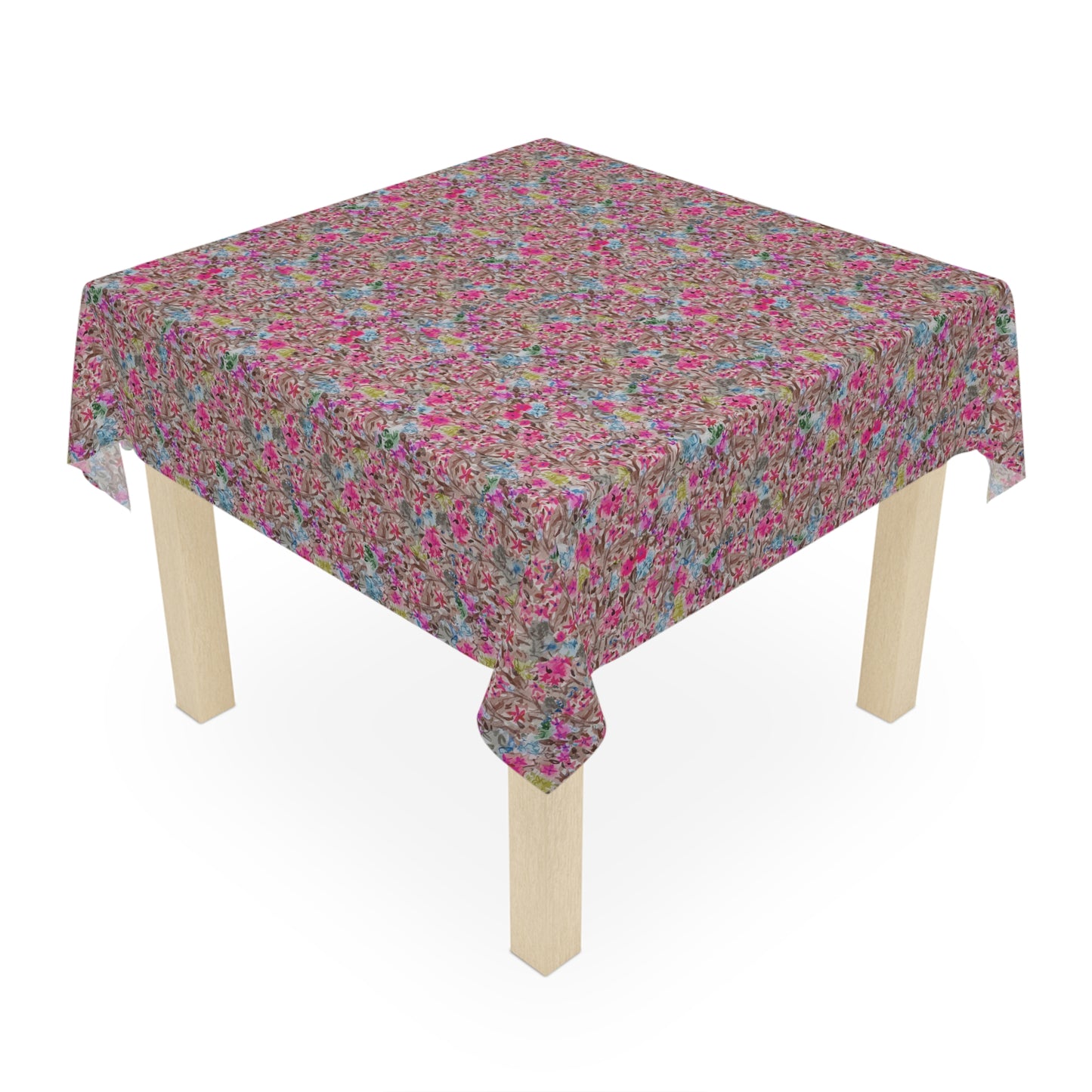 Small wooden table with a floral patterned tablecloth on a white . Modern floral table cover with bold pink blossoms and soft blue highlights background