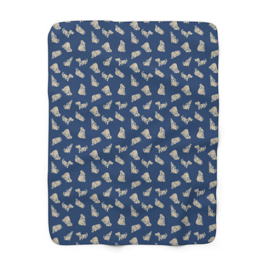 Blue blanket with beige dog pattern on a white background