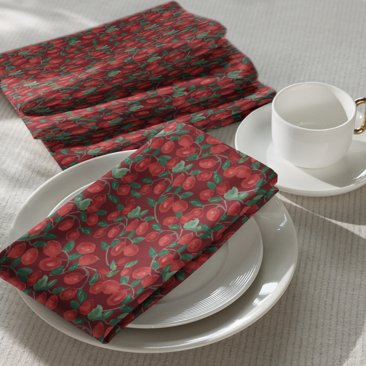 Set of four cloth napkins in Kathryn Young's Cranberry Vine pattern of painterly red cranberries and green vines on a light background