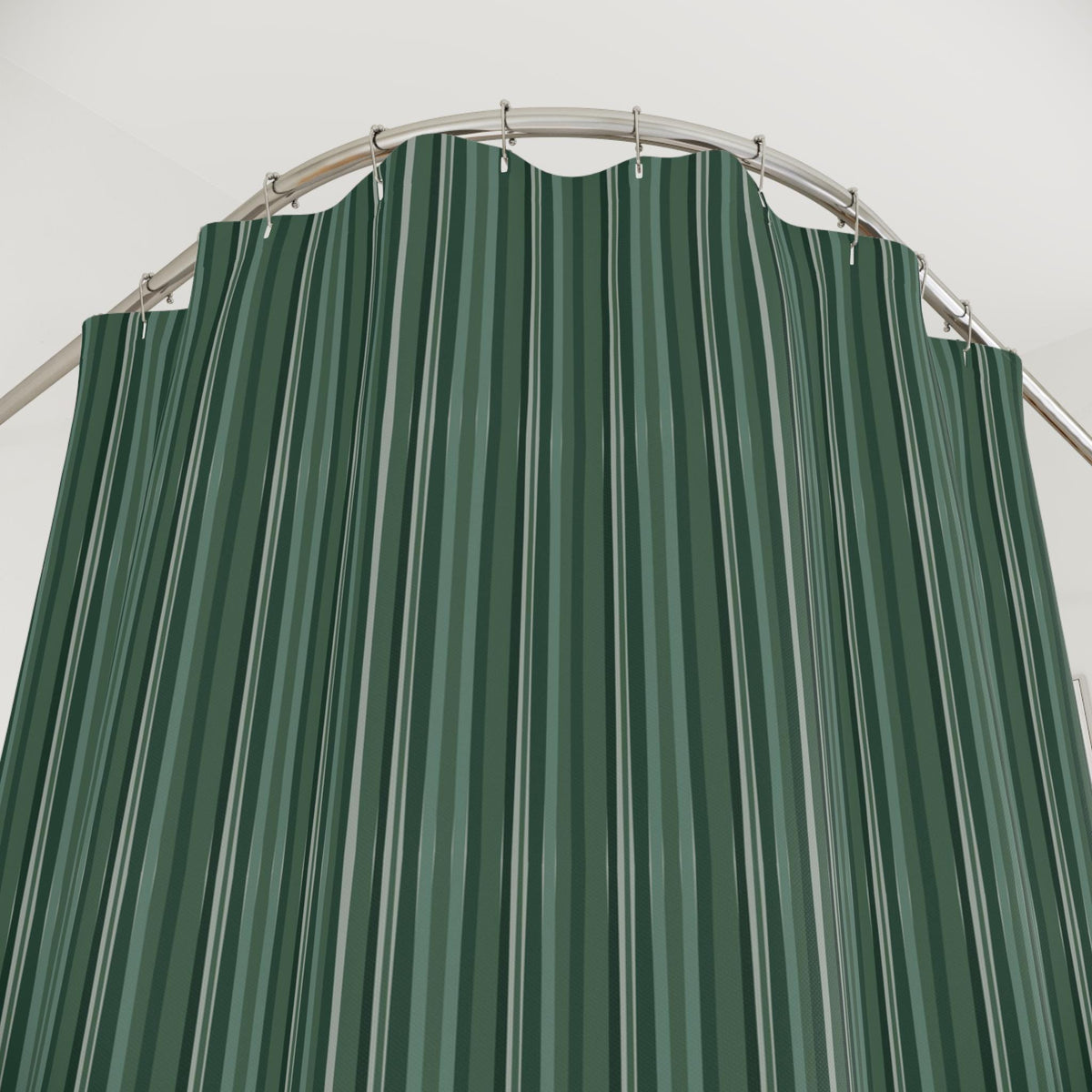 A green and white striped shower curtain hangs from a curved, silver-colored shower rod. The curtain features vertical stripes in varying shades of green and white, creating a simple yet stylish design for a bathroom.
