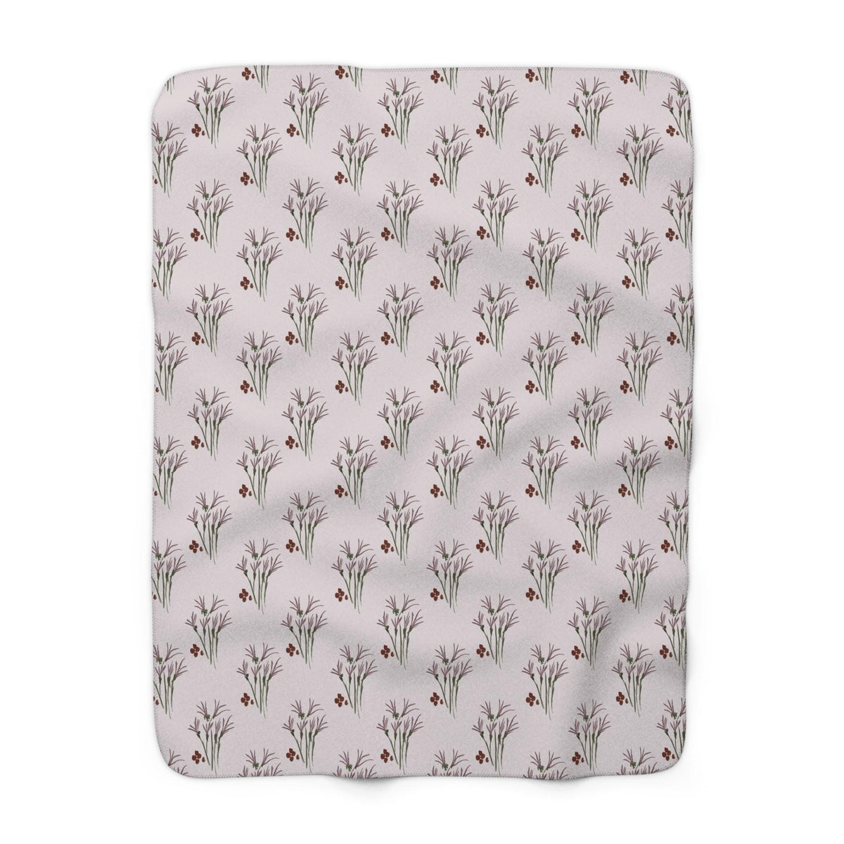 A rectangular blanket with a repeating pattern of stylized floral bouquets and small red berries on a light pink background. The blanket is made of a soft, plush material.
