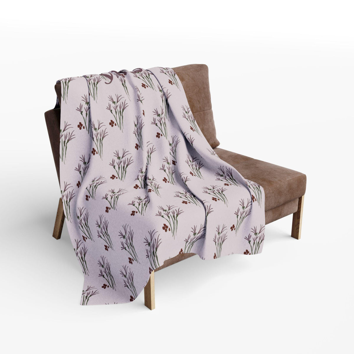 A light purple throw blanket draped over a brown chair. The blanket features a repeating pattern of stylized purple flowers with green stems and small red berries. The chair has a wooden frame.