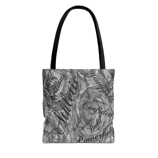 A tote bag with a black handle and a swirling gray and white design. The bag's surface features the word "Athletic" in a large, cursive font, along with other words like "Confident" and "Powerful".