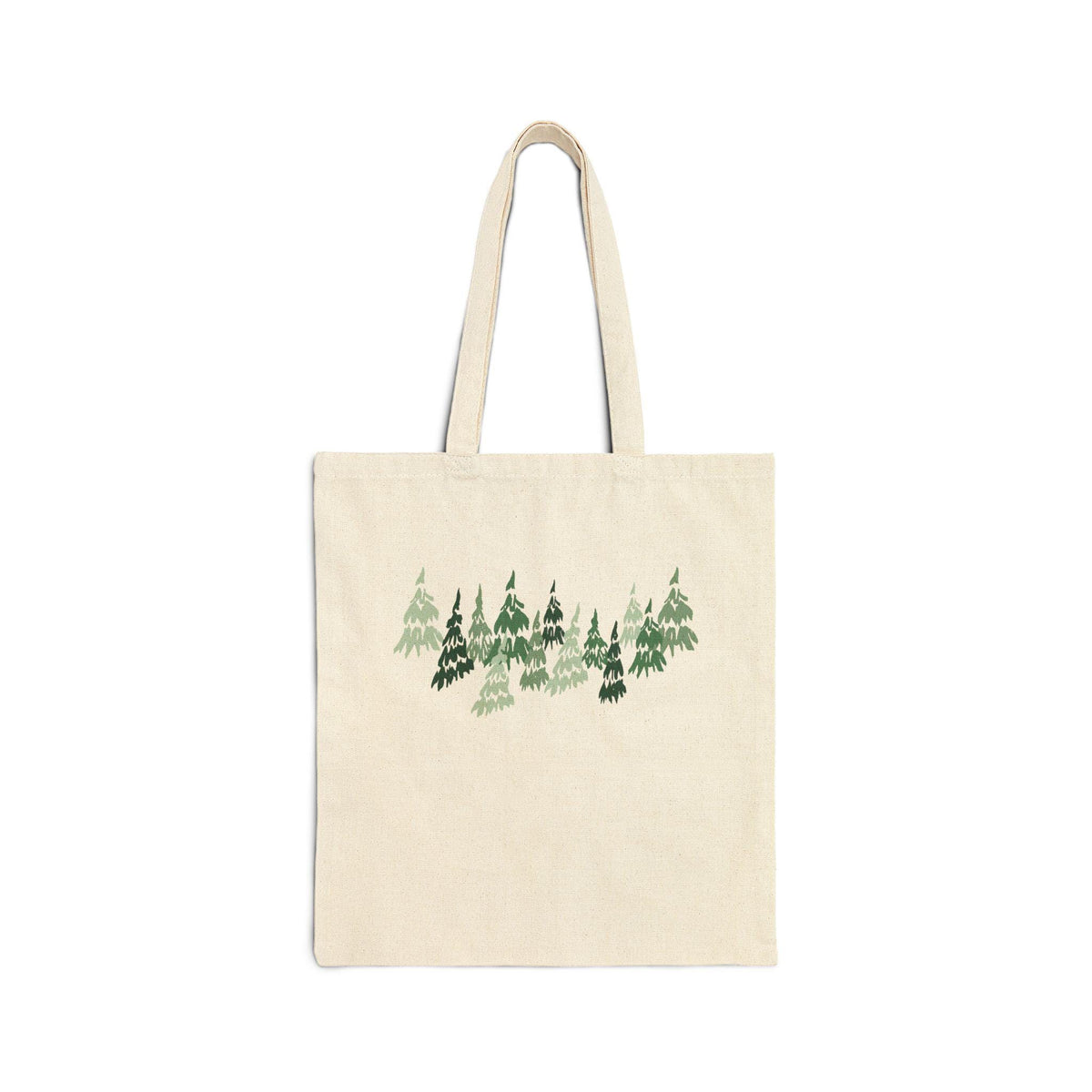 A cream-colored tote bag featuring a forest design in shades of green. The illustration depicts a cluster of stylized evergreen trees. The bag has two handles and is made of a sturdy fabric.