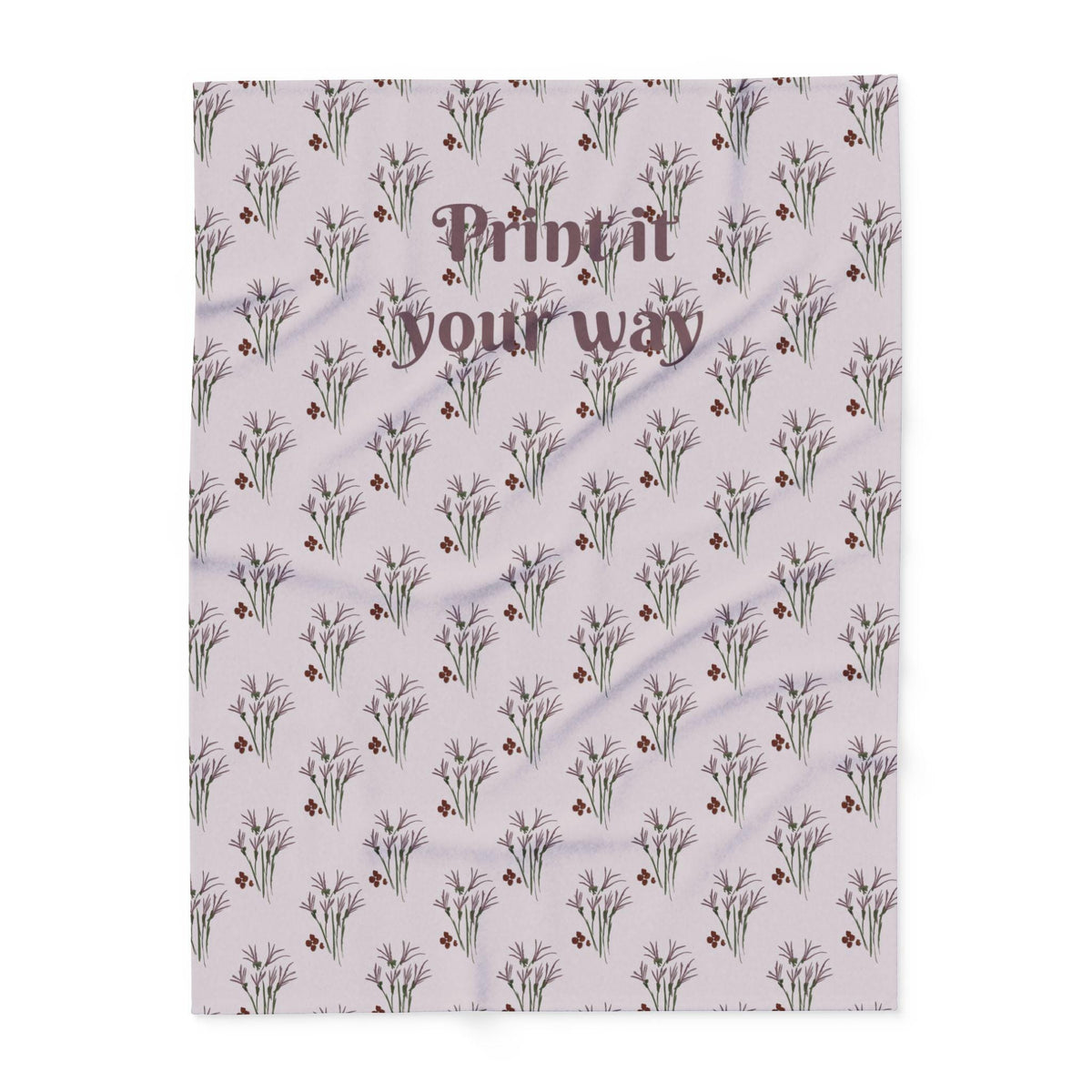 A light purple blanket with a repeating floral pattern of lavender and burgundy accents. The text "Print it your way" is printed in a dark brown script across the top of the blanket.