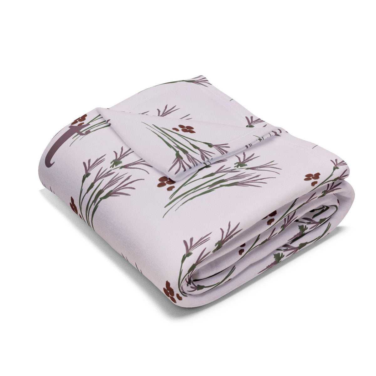 Folded white blanket with a repeating pattern of stylized brown berries and green and purple plant stems. The blanket is folded neatly, showcasing the design. The soft color palette and botanical print suggest a cozy, nature-inspired theme.