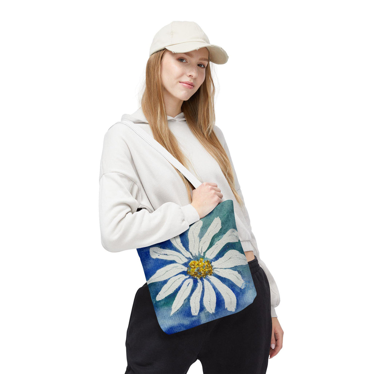 Watercolor daisy tote bag featuring a large hand-painted white daisy with a golden center on a deep blue and teal watercolor background, floral botanical shoulder bag designed from original artwork by Kathryn Young for Good For The Soul Art LLC.