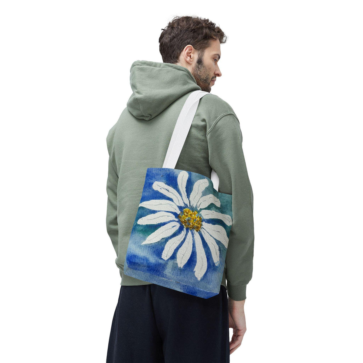 Watercolor daisy tote bag featuring a large hand-painted white daisy with a golden center on a deep blue and teal watercolor background, floral botanical shoulder bag designed from original artwork by Kathryn Young for Good For The Soul Art LLC.