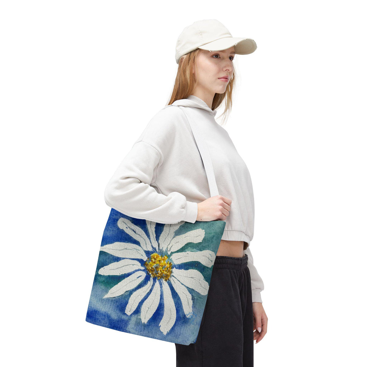 Watercolor daisy tote bag featuring a large hand-painted white daisy with a golden center on a deep blue and teal watercolor background, floral botanical shoulder bag designed from original artwork by Kathryn Young for Good For The Soul Art LLC.