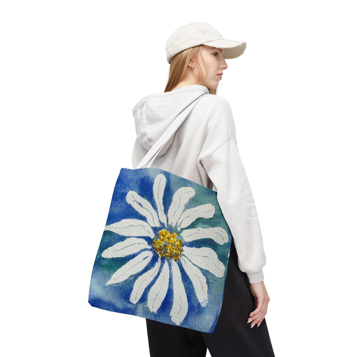 Watercolor daisy tote bag featuring a large hand-painted white daisy with a golden center on a deep blue and teal watercolor background, floral botanical shoulder bag designed from original artwork by Kathryn Young for Good For The Soul Art LLC.