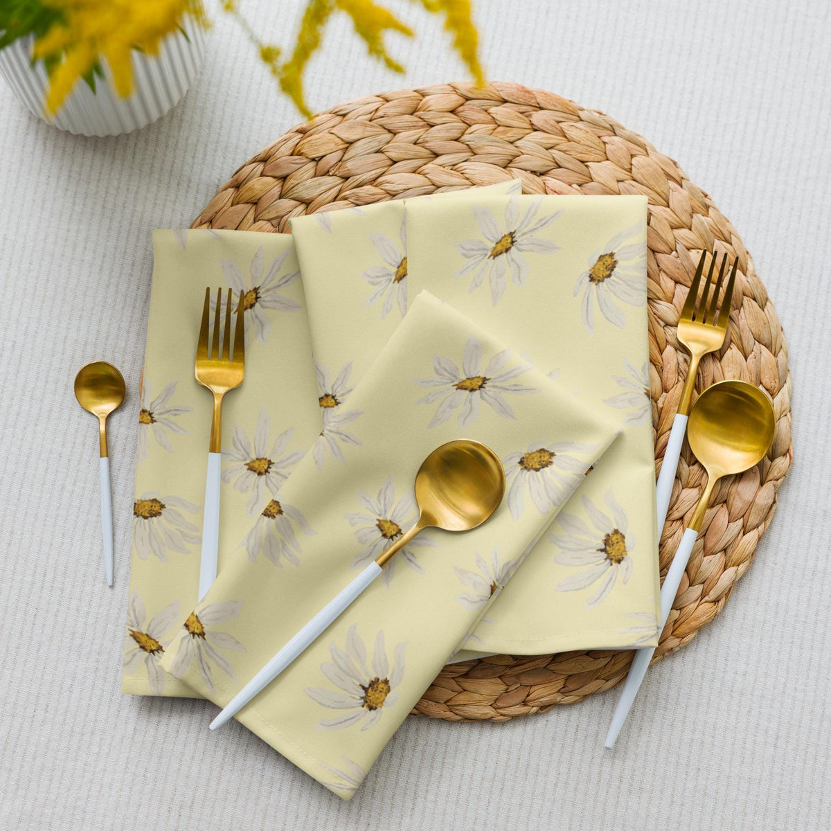 Set of four cloth napkins with watercolor daisies and honey centers on butter yellow